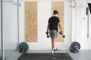 man single leg standing calf raises dumbbell