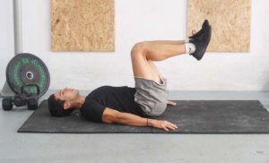 man lying knee raises