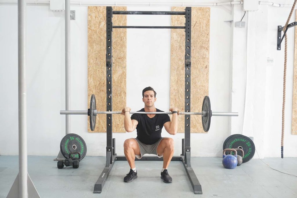 man full front squat barbell