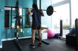 Women squat barbell gym